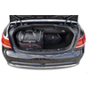 Coffre ouvert d'une voiture noire contenant un grand sac de voyage noir et un sac noir plus petit