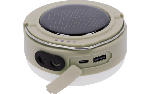 Rundes beige-grünes Gerät mit runder dunkler Fläche mit Linien oben, vier kleinen LEDs und Metallring am Rand, Vorderseite mit zwei runden Tasten, USB-A- und USB-C-Anschluss mit offener Gummikappe beschriftet 'USB'