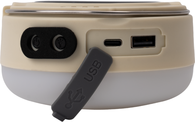 Dispositivo redondo beige con sección inferior blanca translúcida; a la izquierda dos aberturas redondas negras; un puerto USB-C y un puerto USB-A; una tapa de goma gris con la inscripción "USB" cuelga delante de los puertos