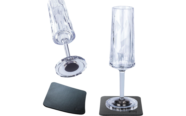 Deux verres à long pied avec un dessous de verre noir, un couché sur le côté, l'autre posé dessus