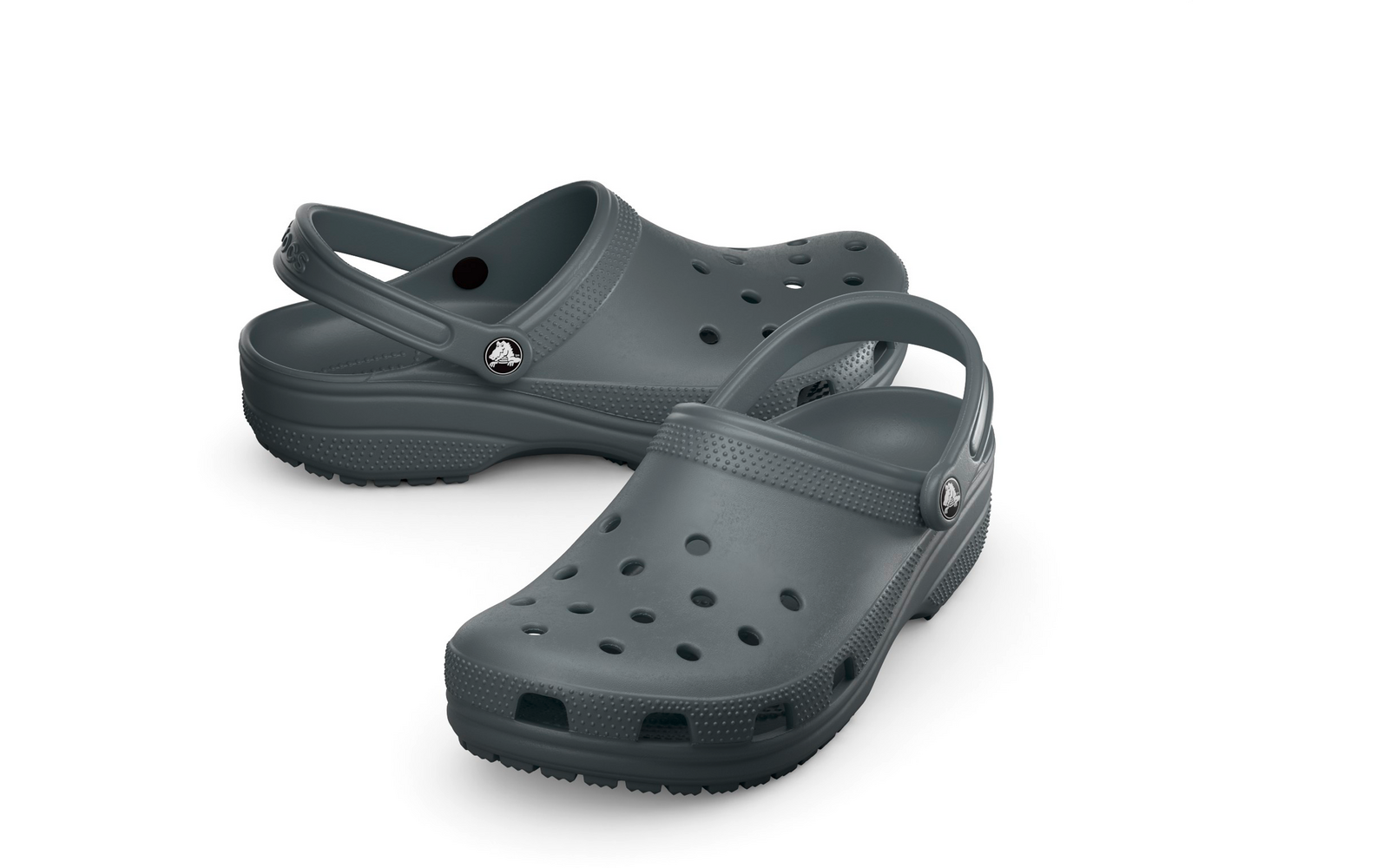 Zwei dunkelgraue Clogs mit Löchern und verstellbarem Fersenriemen, Seitenansicht