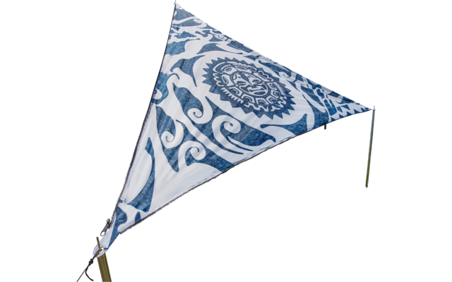 Triangular sail with blue pattern on a meadow, trees and blue sky in the background