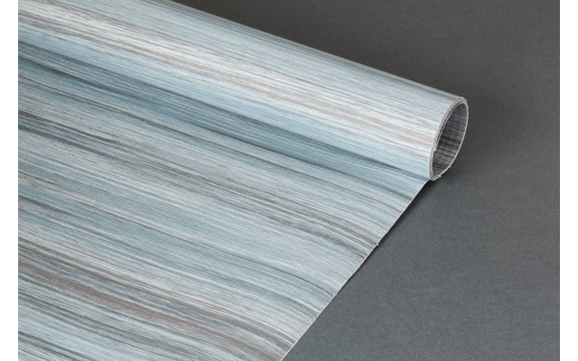 Aufgerolltes Blatt mit blau-grauer Holzmaserung auf dunkelgrauem Hintergrund