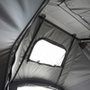 Innenansicht eines Zeltdachs aus grauem Stoff mit Metallgestänge und rechteckigem Fenster mit aufgerollter Abdeckung