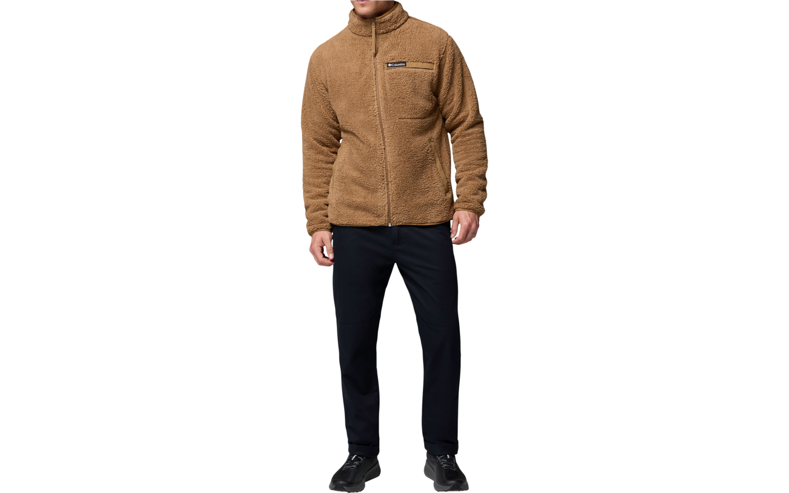 Mann trägt eine braune Jacke und schwarze Hose, steht frontal