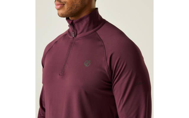 Man draagt een bordeauxkleurig sportshirt met lange mouwen en een rits bij de kraag