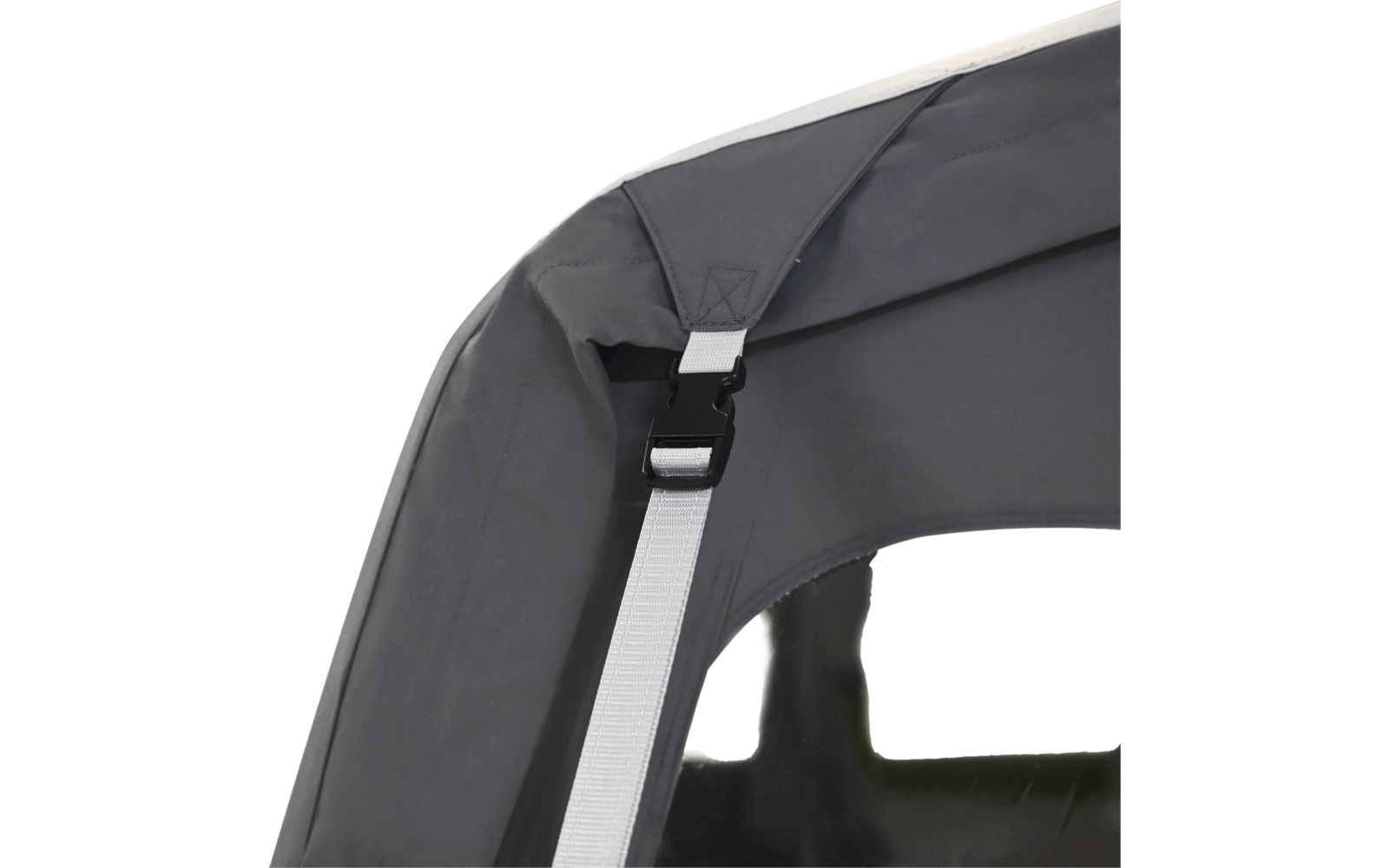 Close-up of a gray fabric edge with a white strap, a black plastic buckle, and a transparent window