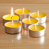 Five yellow tealight candles, one is lit