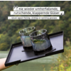 Drei Gläser mit Getränk auf einem schwarzen Tablett vor grüner, unscharfer Landschaft