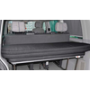 Black folding bed inside a vehicle with three headrests in the background