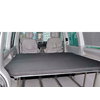 Interior view of a vehicle with folded-down seats and a flat cargo area