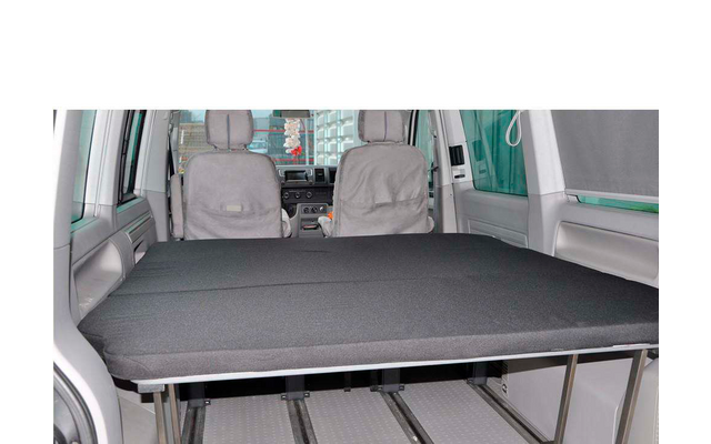 Interior view of a vehicle with folded-down seats and a flat cargo area