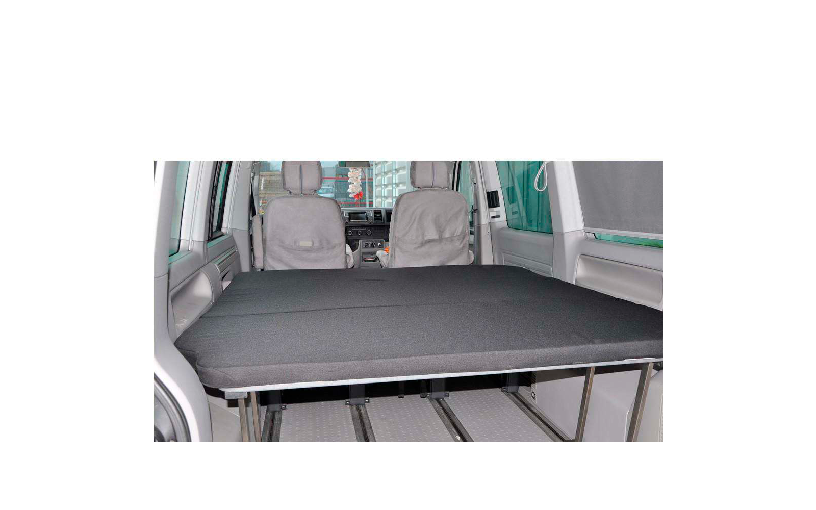 Interior view of a vehicle with folded-down seats and a flat cargo area