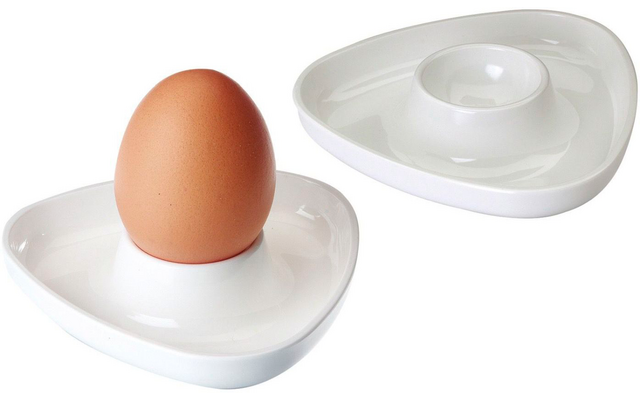 Brown egg standing in a white triangular-shaped egg cup