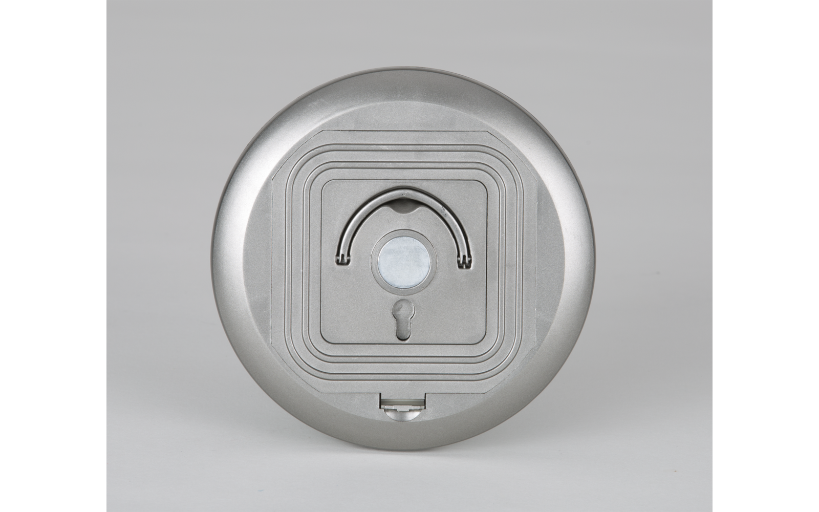 Dispositif rond argenté avec un capteur et un indicateur lumineux au centre