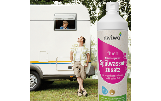 Man standing in front of a caravan, a bottle of dishwasher additive in the foreground