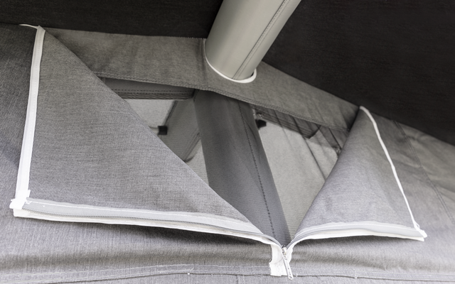 Folded gray pillows with white edges on a gray surface