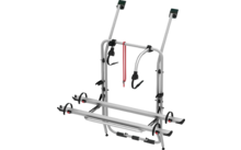 Gray metal bike rack with black clamps and red safety straps
