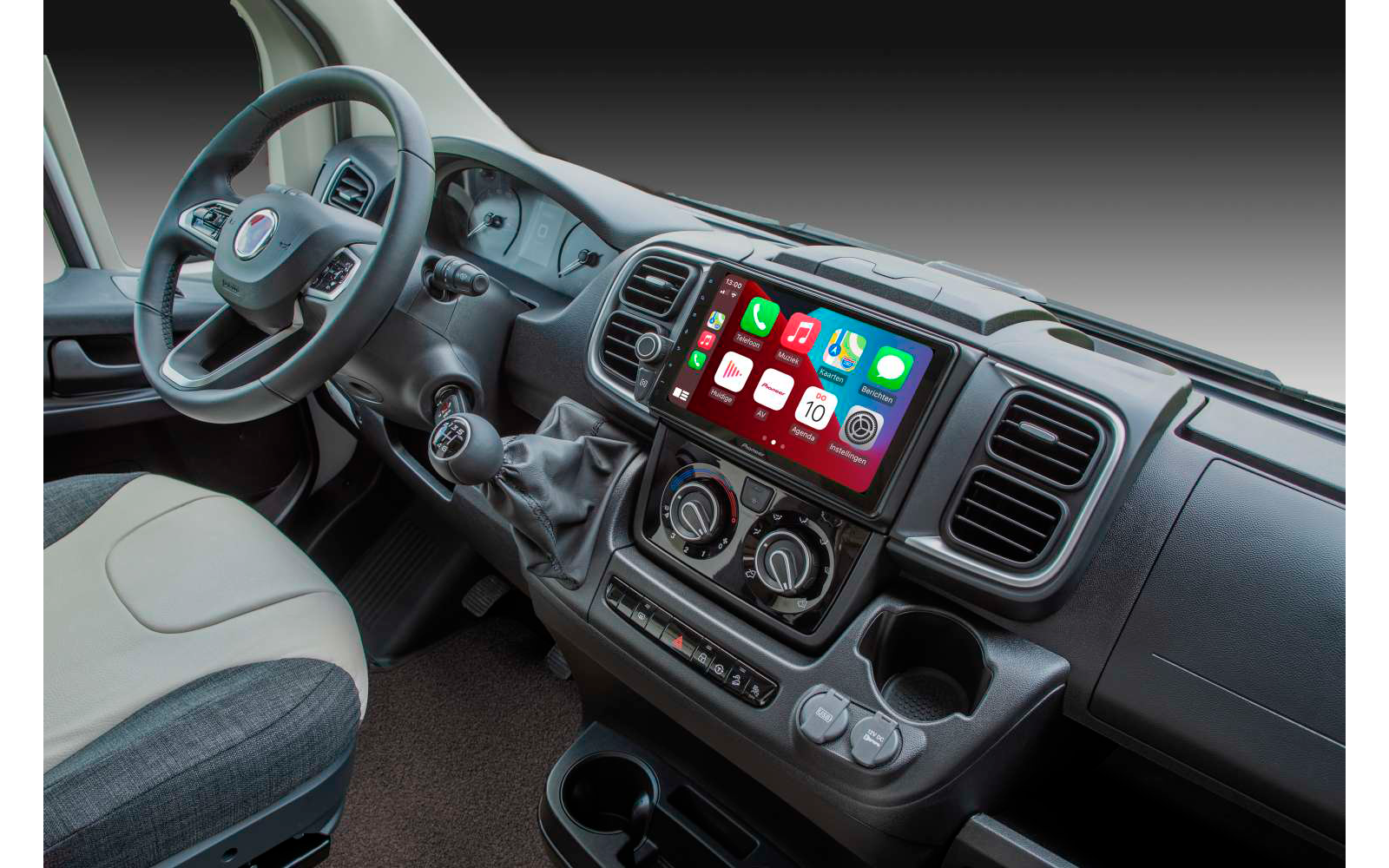 Interior of a vehicle with steering wheel, dashboard, and infotainment system