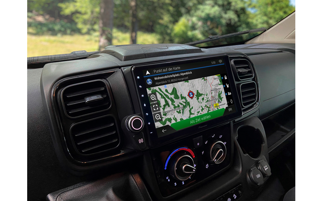 View of a vehicle dashboard with an integrated navigation device and climate control