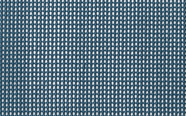 Close-up of perforated metal with evenly spaced round holes