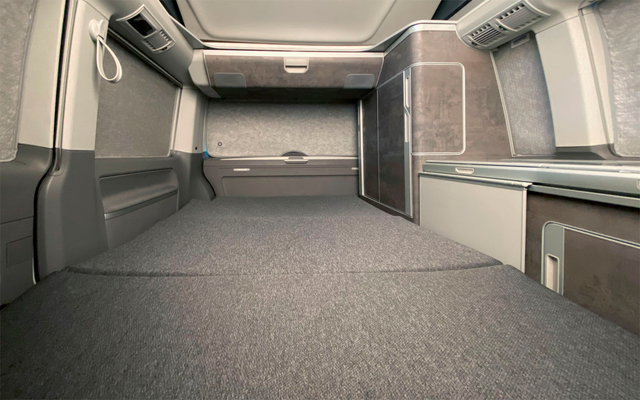 Interior of an empty truck cabin with seat and storage space
