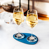 Two glasses of white wine on a blue coaster