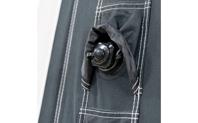 Close-up of a black fabric pouch with a drawstring and white stitching