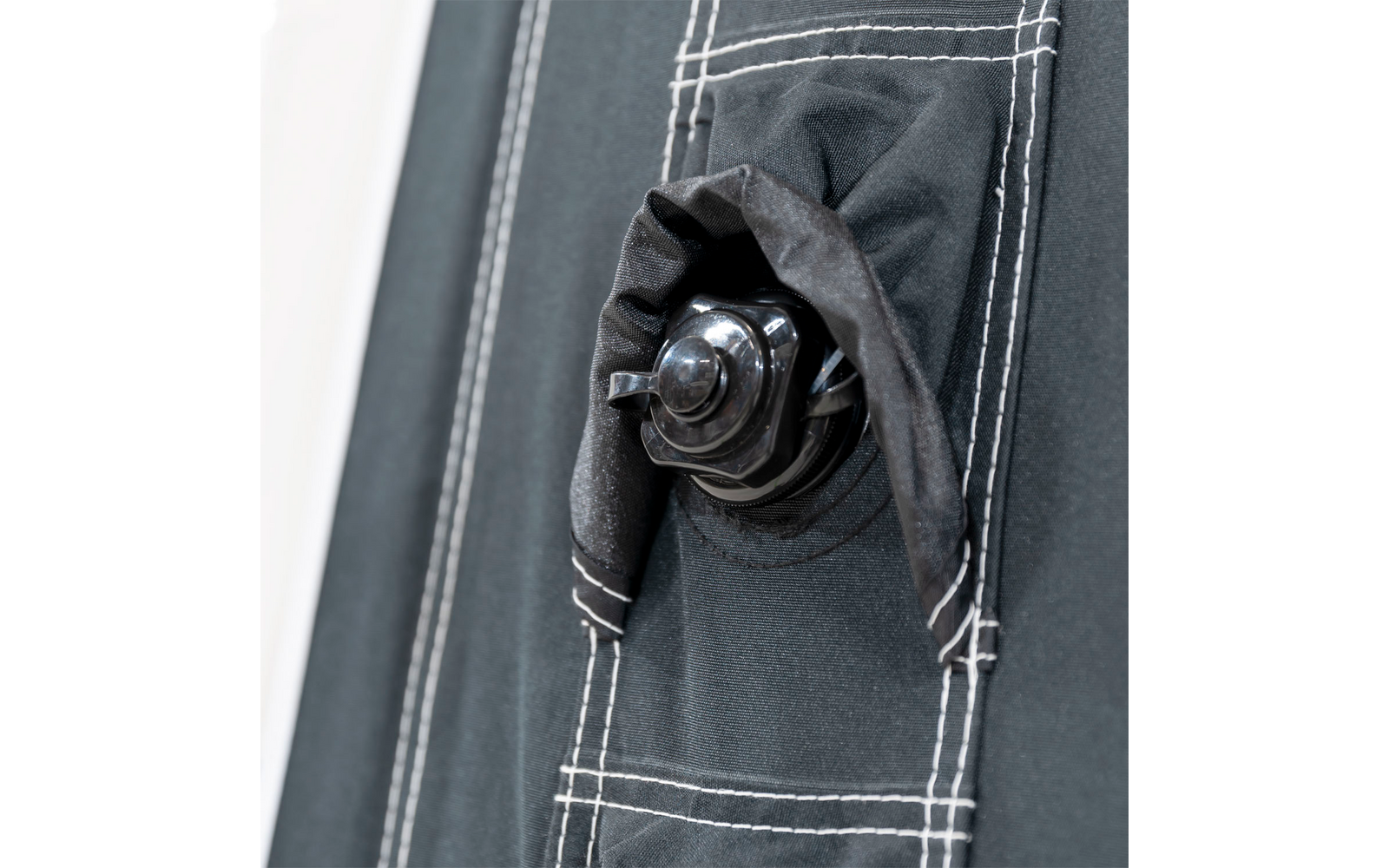 Close-up of a black fabric pouch with a drawstring and white stitching