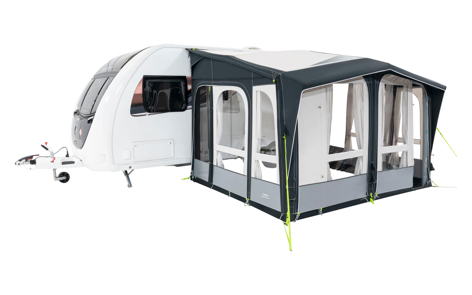 A white caravan with an attached gray awning and windows