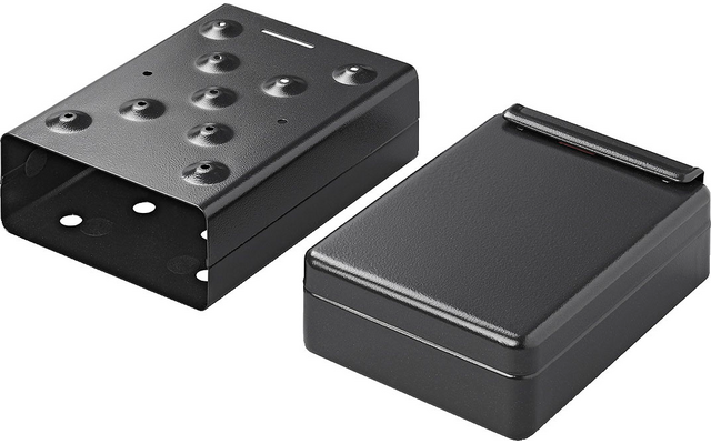 Two black rectangular objects with holes, one flat, one raised