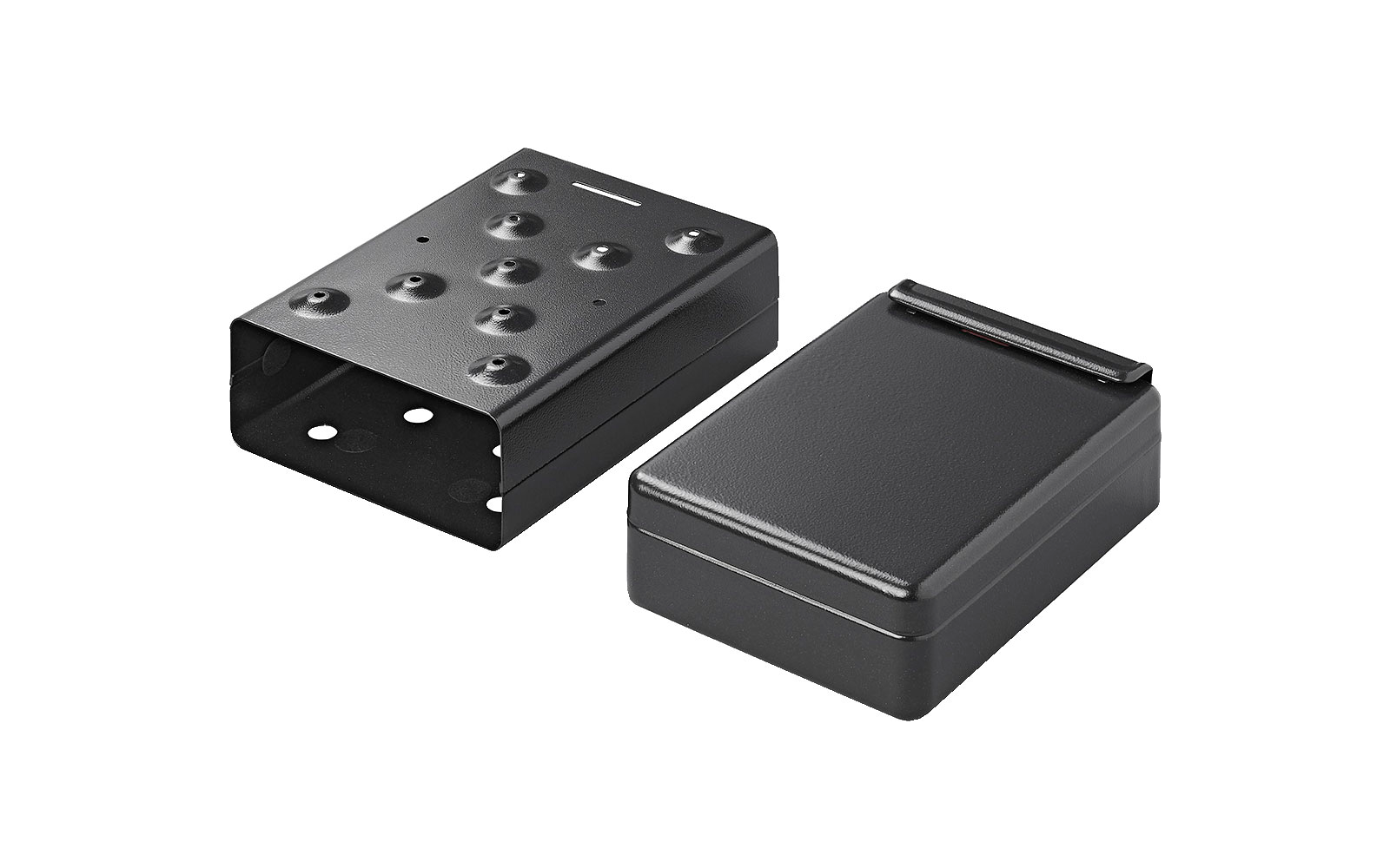 Two black rectangular objects with holes, one flat, one raised