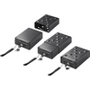 Four black electronic devices with keyboards and antennas, varying in size, on a white background