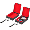 Two opened black cases with red interior, one contains batteries and a charging cable
