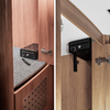 Close-up of a black wall shelf with two hooks on a wooden slat wall