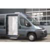 Gray van with open side door in front of a building