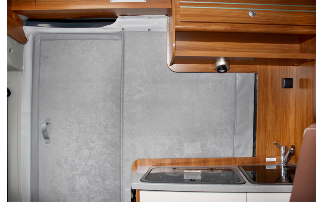Interior of a motorhome with wooden cabinets and kitchen area