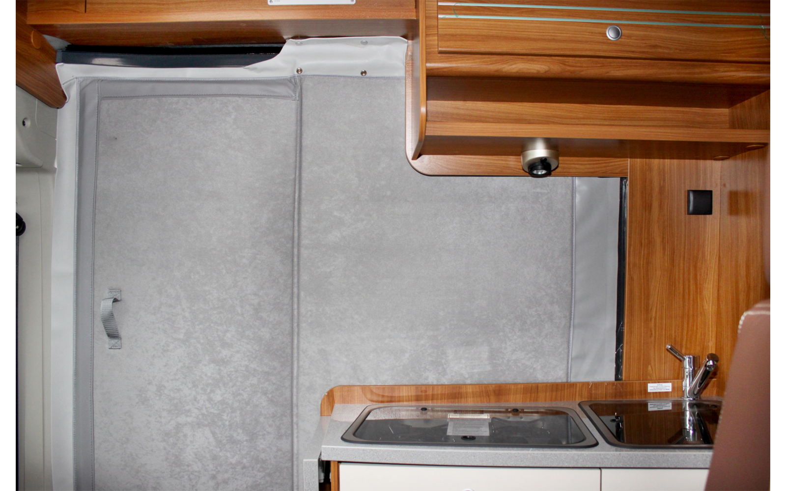 Interior of a motorhome with wooden cabinets and kitchen area