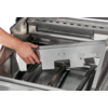 Hand opening a metallic drawer with multiple compartments