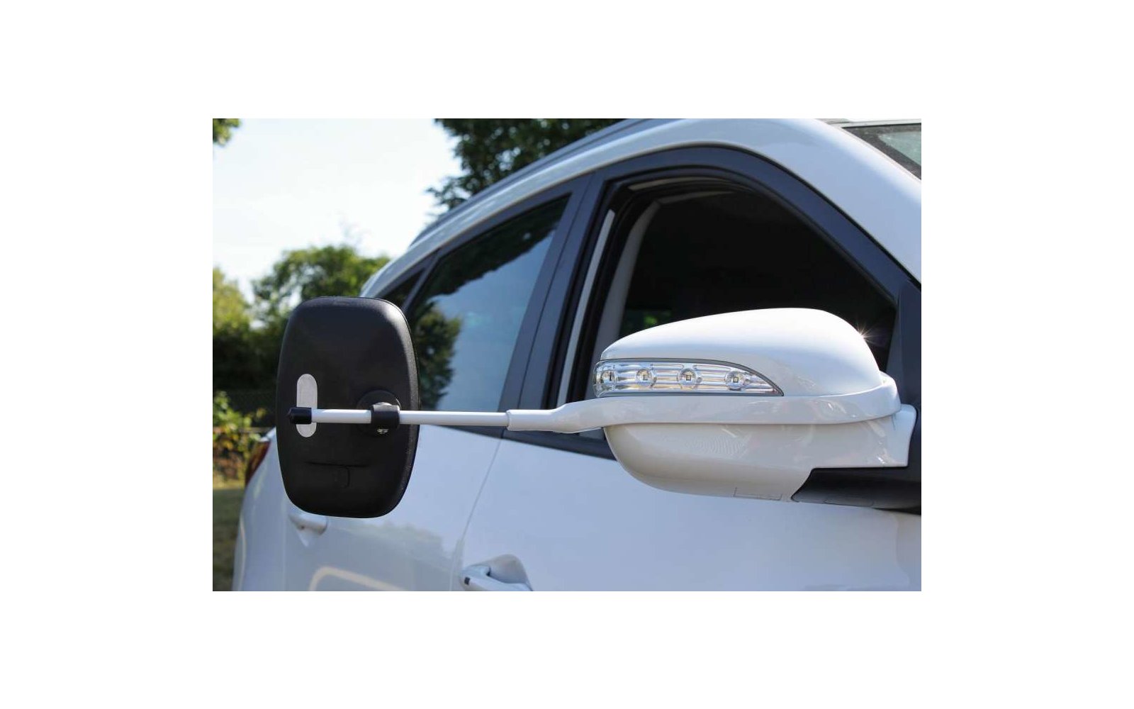 Eine Katze liegt auf einer weißen Fensterbank und blickt nach draußen