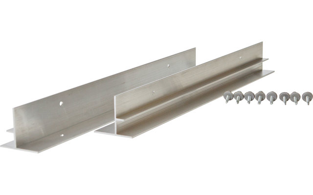 Ein junger Mann sitzt auf einem Ast in einem Wald mit sonnenbeschienenen Bäumen im Hintergrund