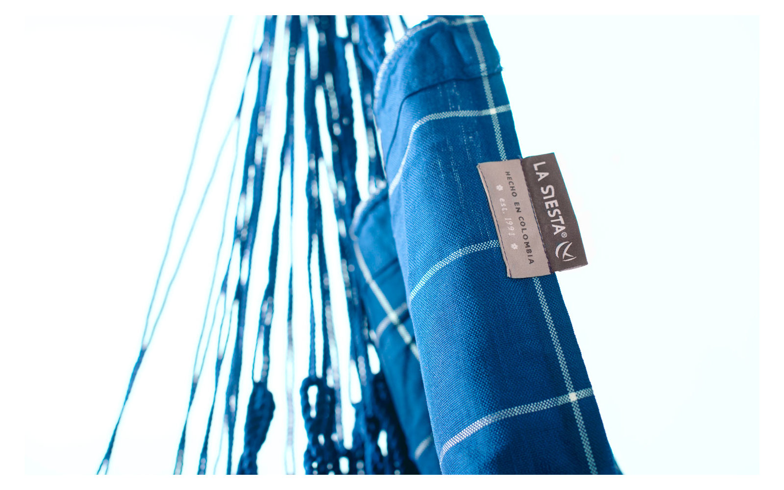 Nahaufnahme eines blauen Hängemattentuchs mit Kordeln und einem Etikett