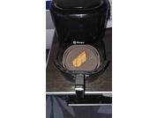 Open air fryer with a toasted piece of bread in the basket