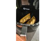 Two triangular slices of bread with green herbs in a black air fryer basket, 'Berger' visible on the appliance